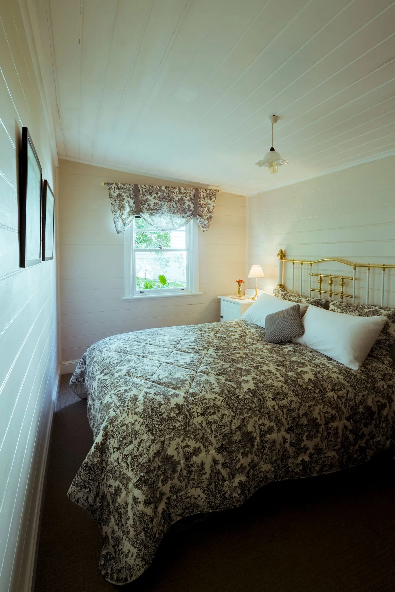 Second queen bedroom with brass bed and toile bedding