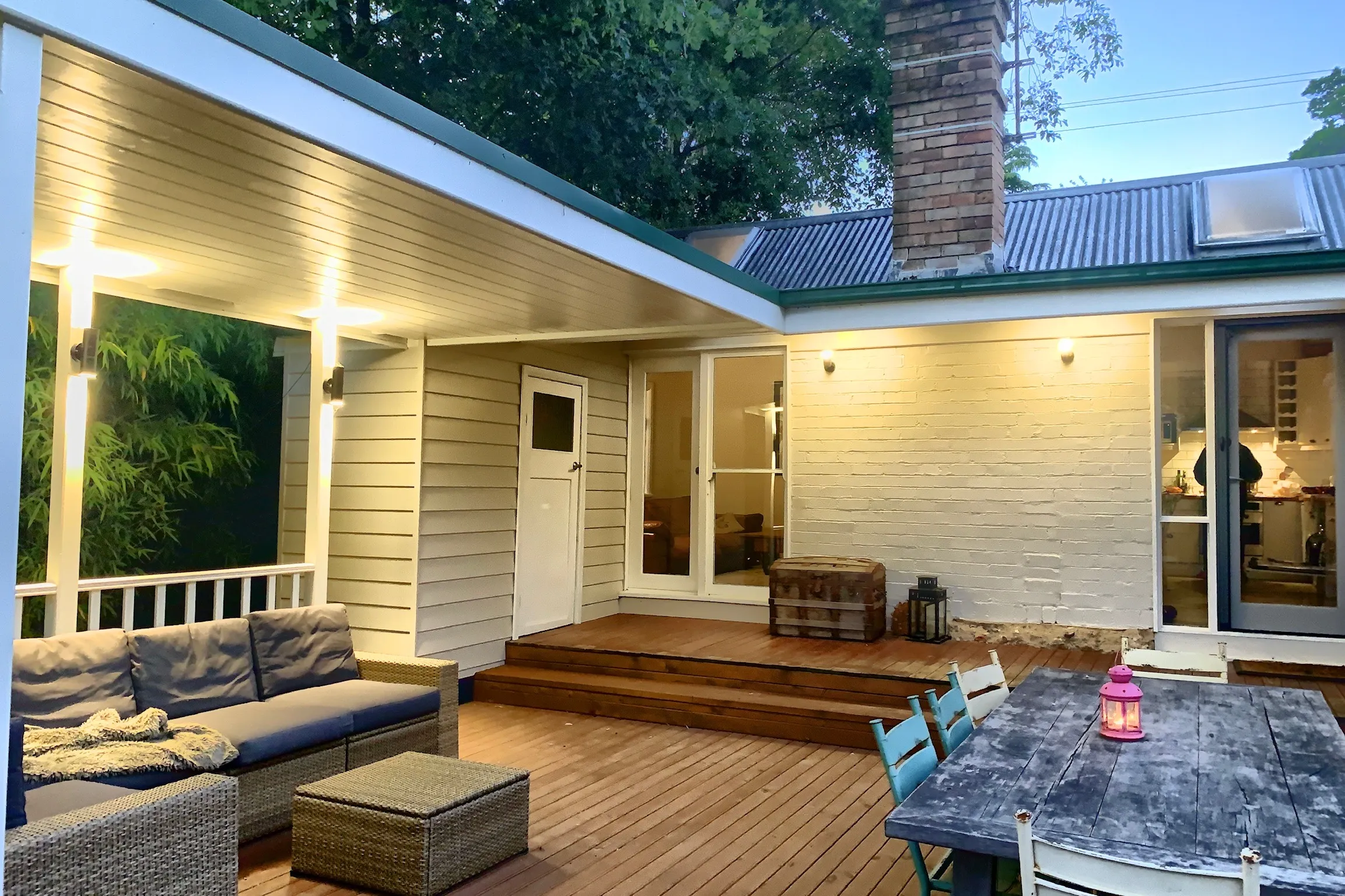 Rear deck and cottage exterior at twilight
